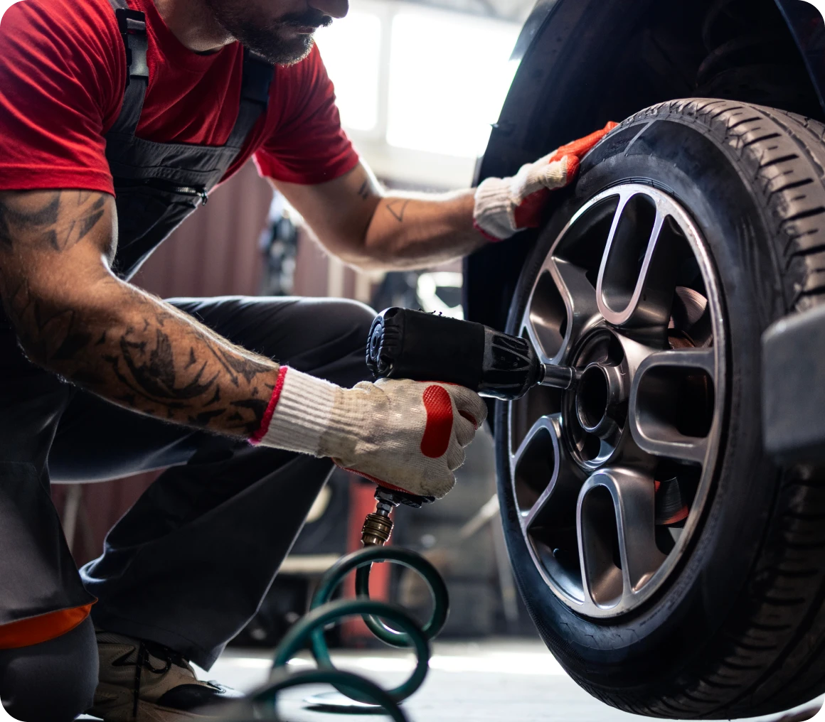 Man using impact wrench on wheel